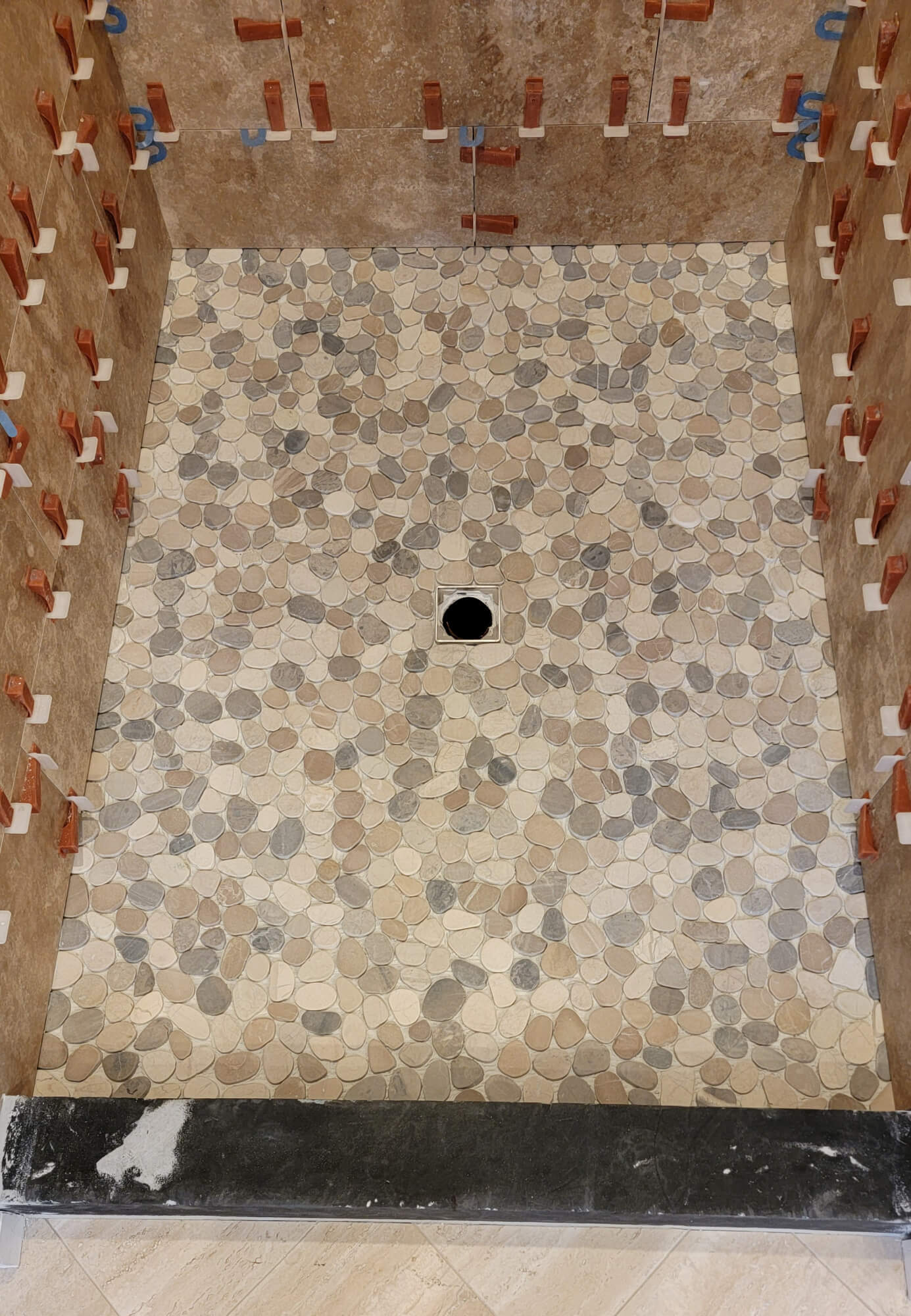 Flat pebble tile on shower floor. Flat pebble tile on shower floor.