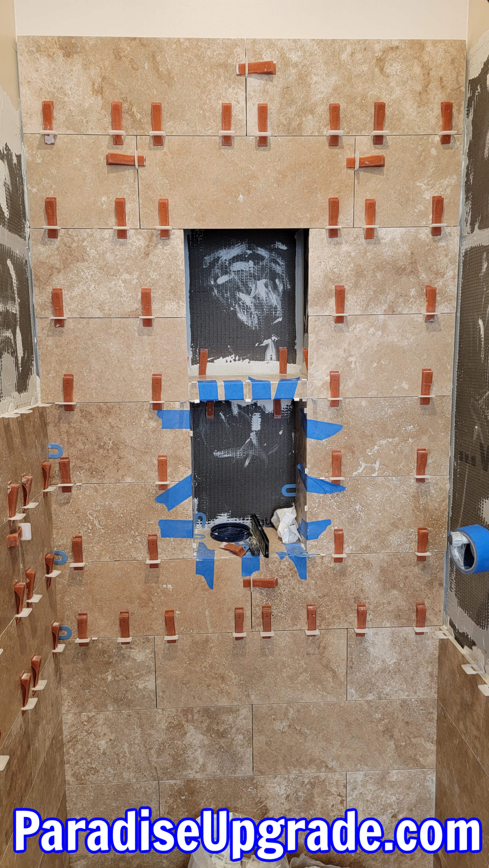 Custom shower niche with travertine tile. Custom shower niche with travertine tile.